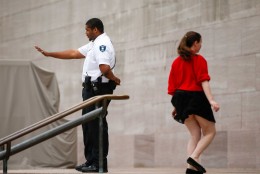 A security guard turns visitors away from the Smithsonian's National Air and Space Museum after widespread power outages caused many of the buildings along the National Mall in Washington to shut down temporarily, Tuesday, April 7, 2015. Widespread power outages affected the White House, State Department, Capitol and other sites across Washington and its suburbs Tuesday afternoon — all because of an explosion at a power plant in southern Maryland, an official said.  (AP Photo/Andrew Harnik)