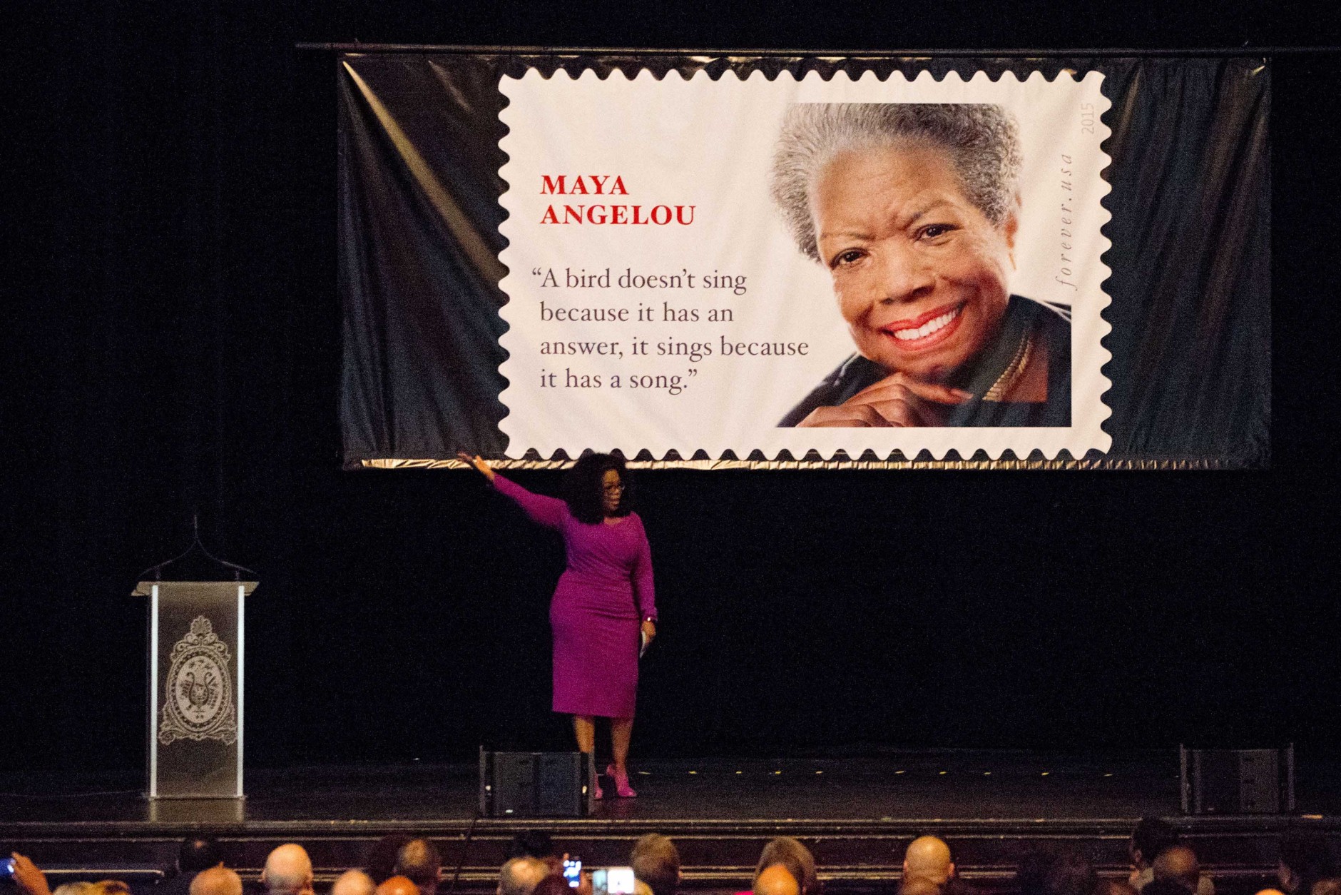 Oprah Winfrey gestures up as the lights go out during her speech at the unveiling of the Maya Angelou Forever Stamp, Tuesday, April 7, 2015, at the Warner Theater  in Washington. The White House, State Department, and Capitol were all affected by reports of widespread power outages across Washington and its suburbs Tuesday afternoon.  (AP Photo/Jacquelyn Martin)