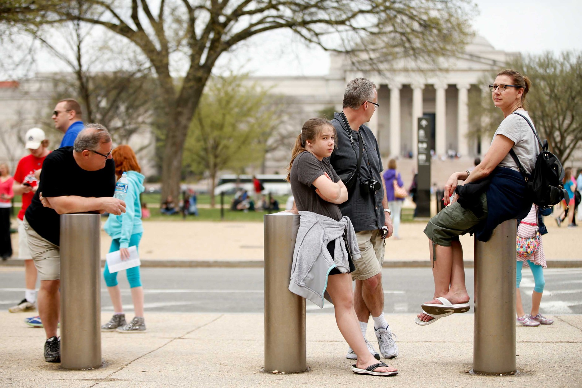 The National Gallery of Art is visible in the background as visitors to the Smithsonian's National Air and Space Museum wait for it to reopen after widespread power outages cause many of the buildings along the National Mall in Washington, to shut down temporarily, Tuesday, April 7, 2015. (AP Photo/Andrew Harnik)