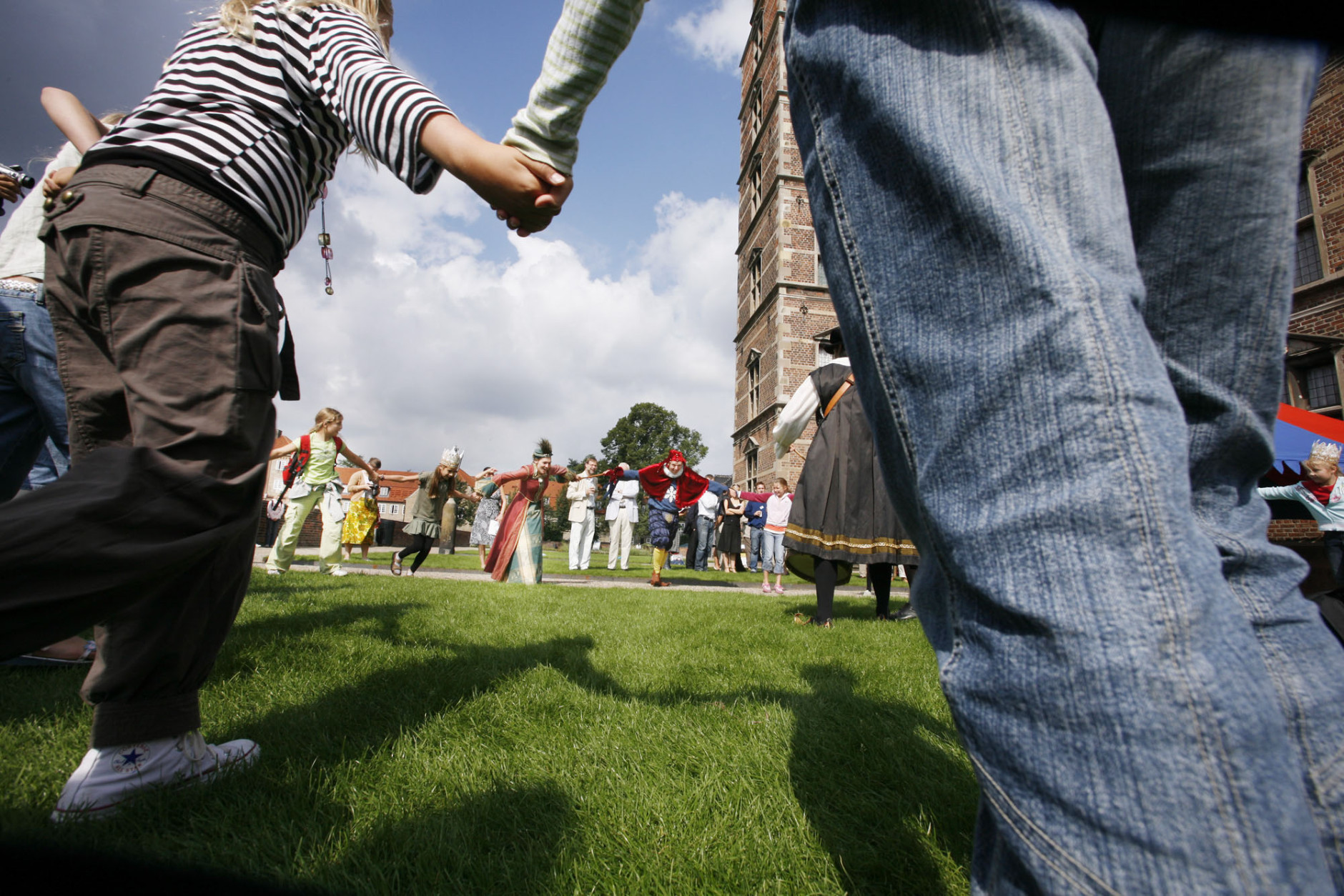 People in medieval dress dance with children on the lawns of the historic Rosenberg Castle in Copenhagen, Denmark Thursday Aug. 24, 2006 during a press preview for the month-long Golden Days renaissance event which will take place in Copenhagen in September. (AP Photo/John McConnico)