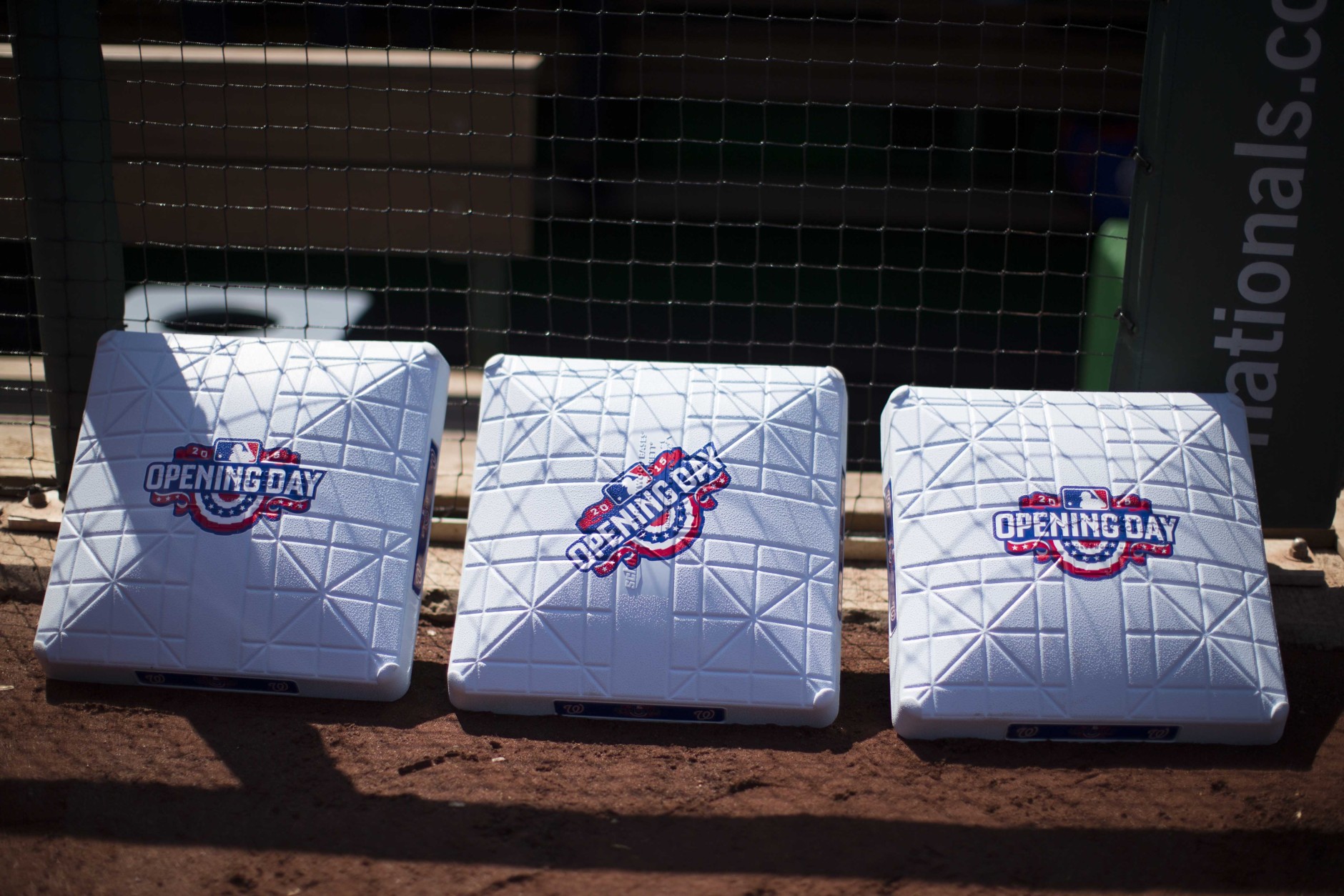 Bases with an opening day logo sit outside a dugout before being installed for a baseball game between the New York Mets and Washington Nationals at Nationals Park on Monday, April 6, 2015, in Washington. (AP Photo/Evan Vucci)