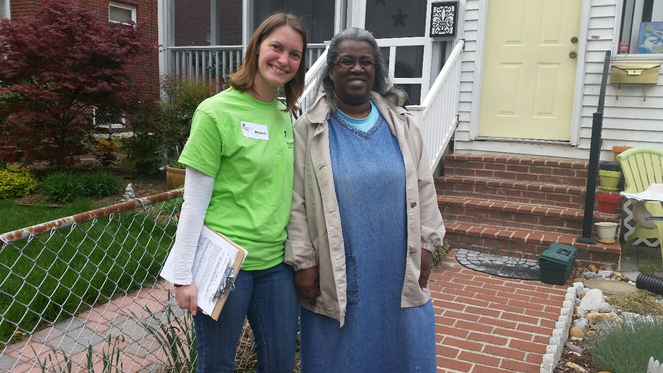 Here, Michelle Cruickshank (left) of Rebuilding Together Alexandria poses with Frances Brown outside her home. Brown needed work done on her home that she otherwise couldn't afford. (WTOP/Kathy Stewart)