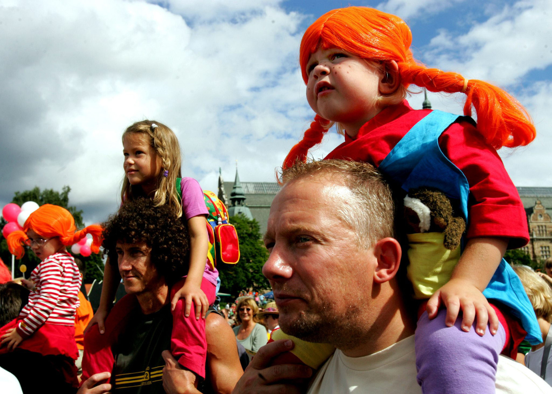 An unidentified young girl dressed up as Pippi Longstocking riding piggyback on her father at the 60th anniversary of the popular Swedish children's book heroine Pippi, in Stockholm, Saturday, Aug. 13, 2005. (AP Photo/Jack Mikrut)  SWEDEN OUT