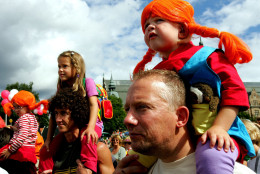 An unidentified young girl dressed up as Pippi Longstocking riding piggyback on her father at the 60th anniversary of the popular Swedish children's book heroine Pippi, in Stockholm, Saturday, Aug. 13, 2005. (AP Photo/Jack Mikrut)  SWEDEN OUT