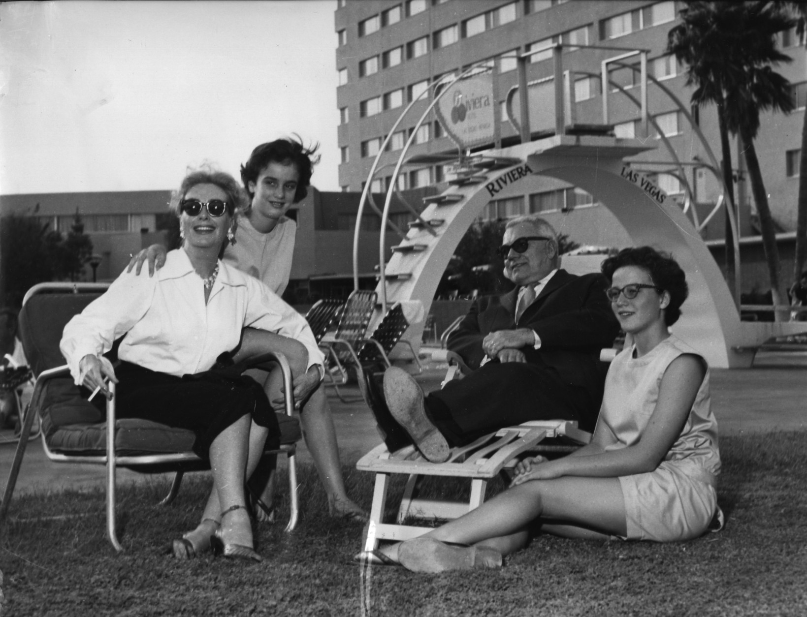 Actress Joan Crawford, left, relaxes with her husband Alfred N. Steele, and her 11-year-old twin daughters Cathy and Cindy at tthe pool of Las Vegas Riviera Hotel, USA, October 1958.  (AP Photo)