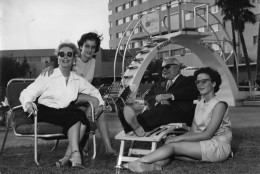 Actress Joan Crawford, left, relaxes with her husband Alfred N. Steele, and her 11-year-old twin daughters Cathy and Cindy at tthe pool of Las Vegas Riviera Hotel, USA, October 1958.  (AP Photo)