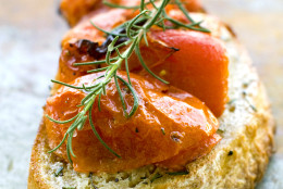 This July 11, 2011 photo shows buttery roasted tomato bruschetta in Concord, N.H.  This bruschetta recipe gets a pat of butter added at the end just before serving.   (AP Photo/Matthew Mead)