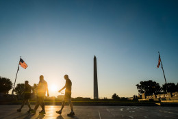 US Army soldiers walk through the World War II Memorial and past the Washington Monument in Washington, Friday, May 22, 2015, after their early morning workout at the start of the Memorial Day Weekend. (AP Photo/J. David Ake)