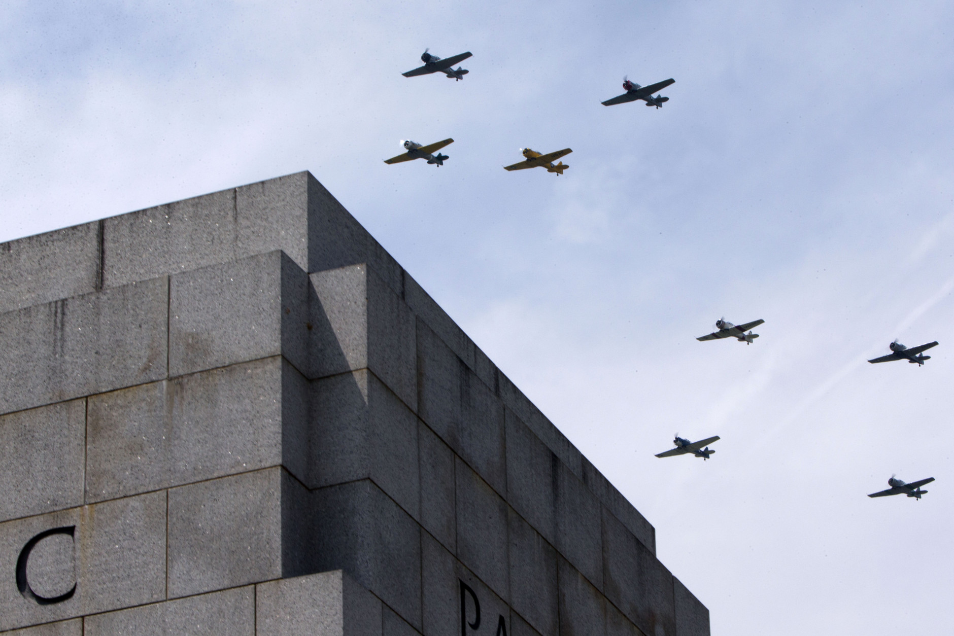 World War II aircraft fly over the World War II Memorial in Washington, Friday, May 8, 2015, in honor of the 70th anniversary of Victory in Europe Day (VE Day), during the Arsenal of Democracy: World War II Victory Capitol Flyover. The Flyover above the National Mall features historically sequenced formations of more than 50 vintage World War II aircraft. (AP Photo/Jacquelyn Martin)