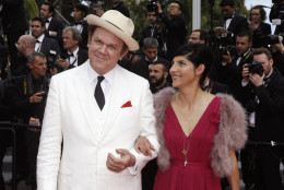 Actor John C. Reilly, left, and his partner Alison Dickey pose for photographers upon arrival for the awards ceremony at the 68th international film festival, Cannes, southern France, Sunday, May 24, 2015. (AP Photo/Lionel Cironneau)