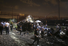 Emergency personnel work the scene of a train wreck, Tuesday, May 12, 2015, in Philadelphia. An Amtrak train headed to New York City derailed and crashed in Philadelphia. (AP Photo/Joseph Kaczmarek)