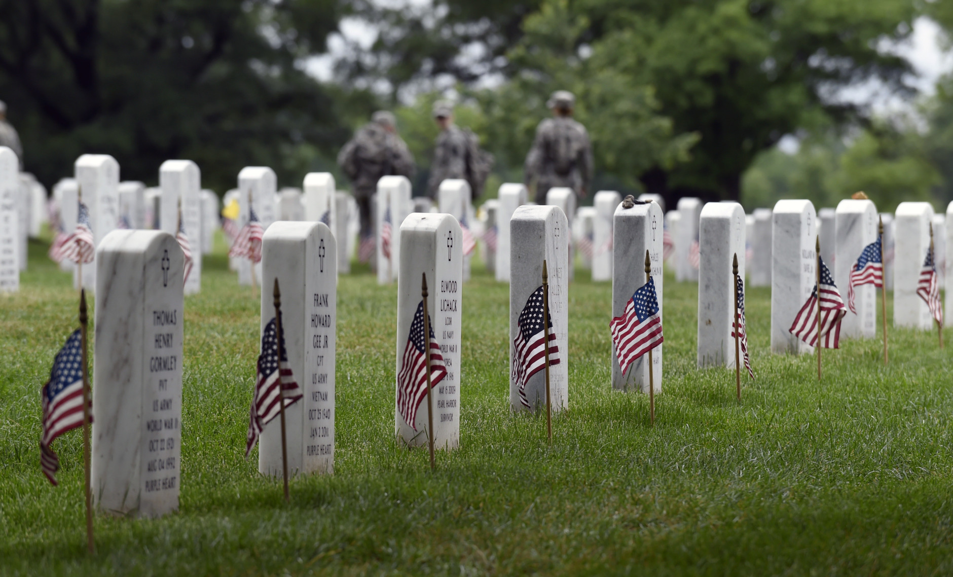 Members of the 3rd U.S. Infantry Regiment (The Old Guard) place a flag in front of each headstone at Arlington National Cemetery in Arlington, Va., Thursday, May 21, 2015. "Flags In" is an annual tradition that is reserved for The Old Guard since its designation as the Armys official ceremonial unit in 1948. They conduct the mission annually at Arlington National Cemetery and the U.S. Soldiers' and Airmen's Home National Cemetery prior to Memorial Day to honor the nations fallen military heroes. (AP Photo/Susan Walsh)