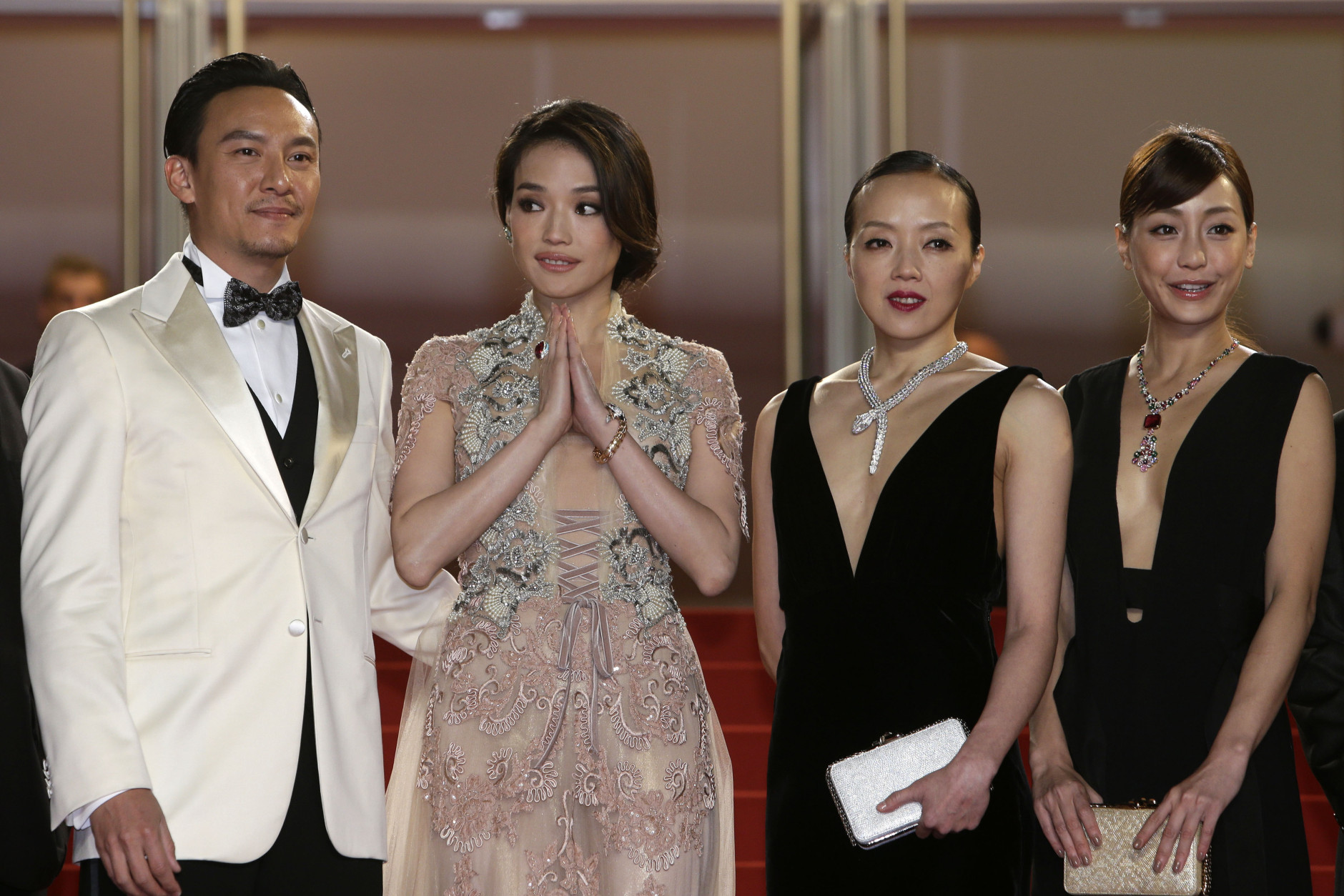 From left, actors Chang Chen, Shu Qi, Sheu Fang-Yi, and Hsieh Hsin-Ying pose for photographers as they arrive for the screening of the film Nie Yinniang (The Assassin) at the 68th international film festival, Cannes, southern France, Thursday, May 21, 2015. (AP Photo/Lionel Cironneau)