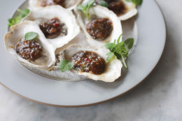 This Apr. 7, 2014 photo shows grilled oysters with fermented black beans and chili garlic in Concord, N.H. This recipe was inspired by chefs at the South Beach Wine and Food Festival in Miami Beach, Fla. (AP Photo/Matthew Mead)
