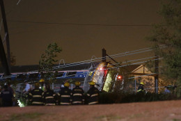 Emergency personnel work the scene of a train wreck, Tuesday, May 12, 2015, in Philadelphia. An Amtrak train headed to New York City derailed and crashed in Philadelphia. (AP Photo/Matt Slocum)