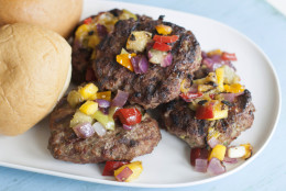 This April 28, 2014 photo shows grilled tomatillo and nectarine salsa over blue cheese meatloaf burgers in Concord, N.H. This summer grilling recipe combines meat, vegetables and fruit. (AP Photo/Matthew Mead)
