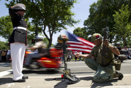 Marine Tim Chamber and Army Eric Cantu salutes as motorcycles drive past during the annual Rolling Thunder parade ahead of Memorial Day in Washington, Sunday, May 24, 2015. (AP Photo/Jose Luis Magana)