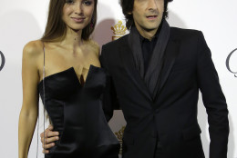 Actor Adrian Brody, right, and partner  Lara Lieto pose for photographers upon arrival for the De Grisogono party at the Hotel du Cap-Eden-Roc, on the sidelines of the 68th Cannes international film festival, Cap d'Antibes, southern France, Tuesday, May 19, 2015. (AP Photo/Thibault Camus)