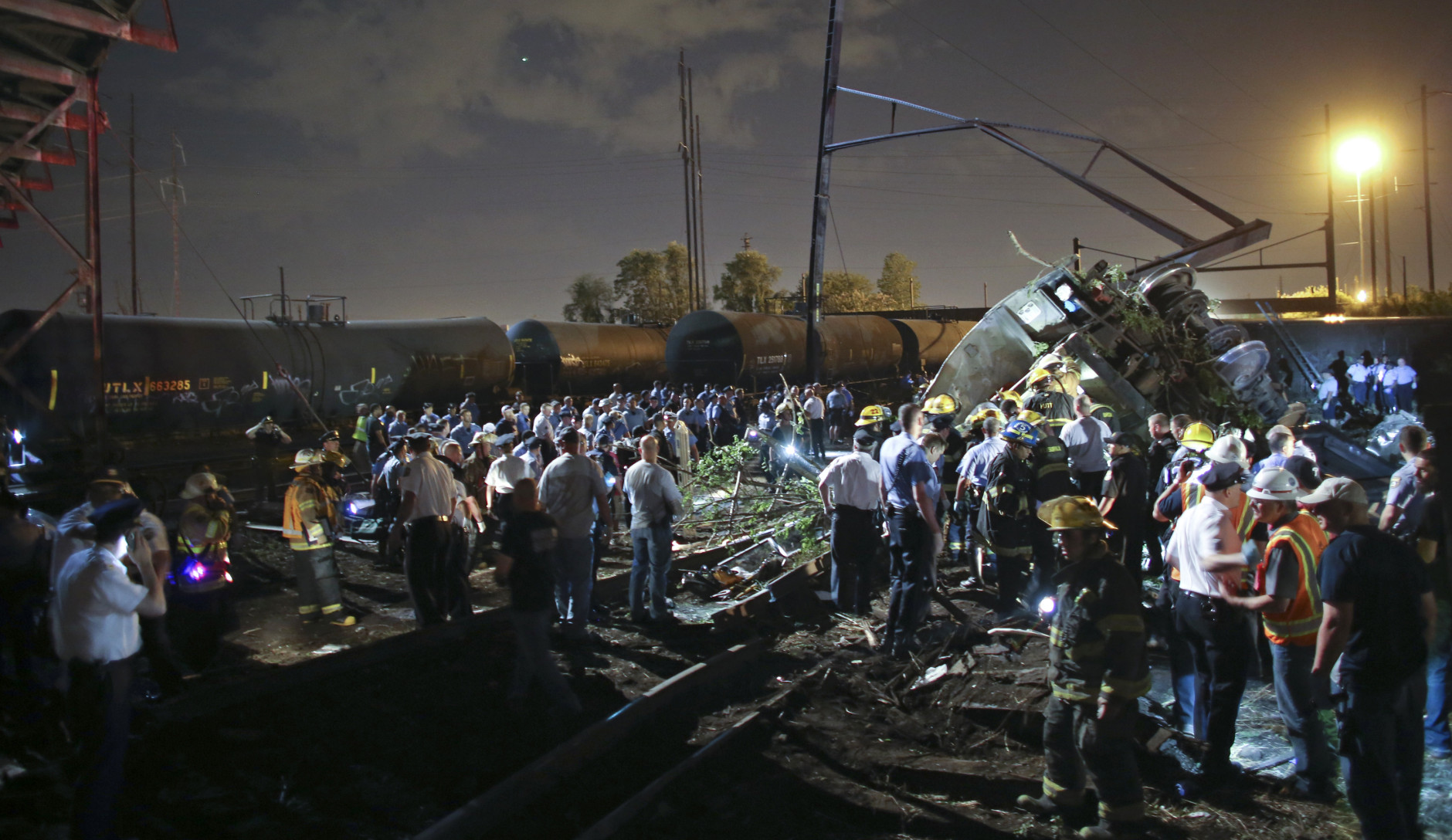 Emergency personnel work the scene of a train wreck, Tuesday, May 12, 2015, in Philadelphia. An Amtrak train headed to New York City derailed and crashed in Philadelphia. (AP Photo/ Joseph Kaczmarek)