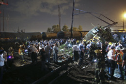 Emergency personnel work the scene of a train wreck, Tuesday, May 12, 2015, in Philadelphia. An Amtrak train headed to New York City derailed and crashed in Philadelphia. (AP Photo/ Joseph Kaczmarek)