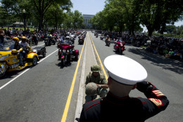 CORRECTS SPELLING TO TIM NOT TIME   Marine Tim Chamber and Army Eric Cantu salutes as motorcycles drive past during the annual Rolling Thunder parade ahead of Memorial Day in Washington, Sunday, May 24, 2015. (AP Photo/Jose Luis Magana)