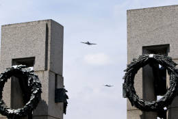 World War II aircraft fly over the World War II Memorial in Washington, Friday, May 8, 2015, in honor of the 70th anniversary of Victory in Europe Day (VE Day), during the Arsenal of Democracy: World War II Victory Capitol Flyover.   The Flyover above the National Mall features historically sequenced formations of more than 50 vintage World War II aircraft. (AP Photo/Jacquelyn Martin)
