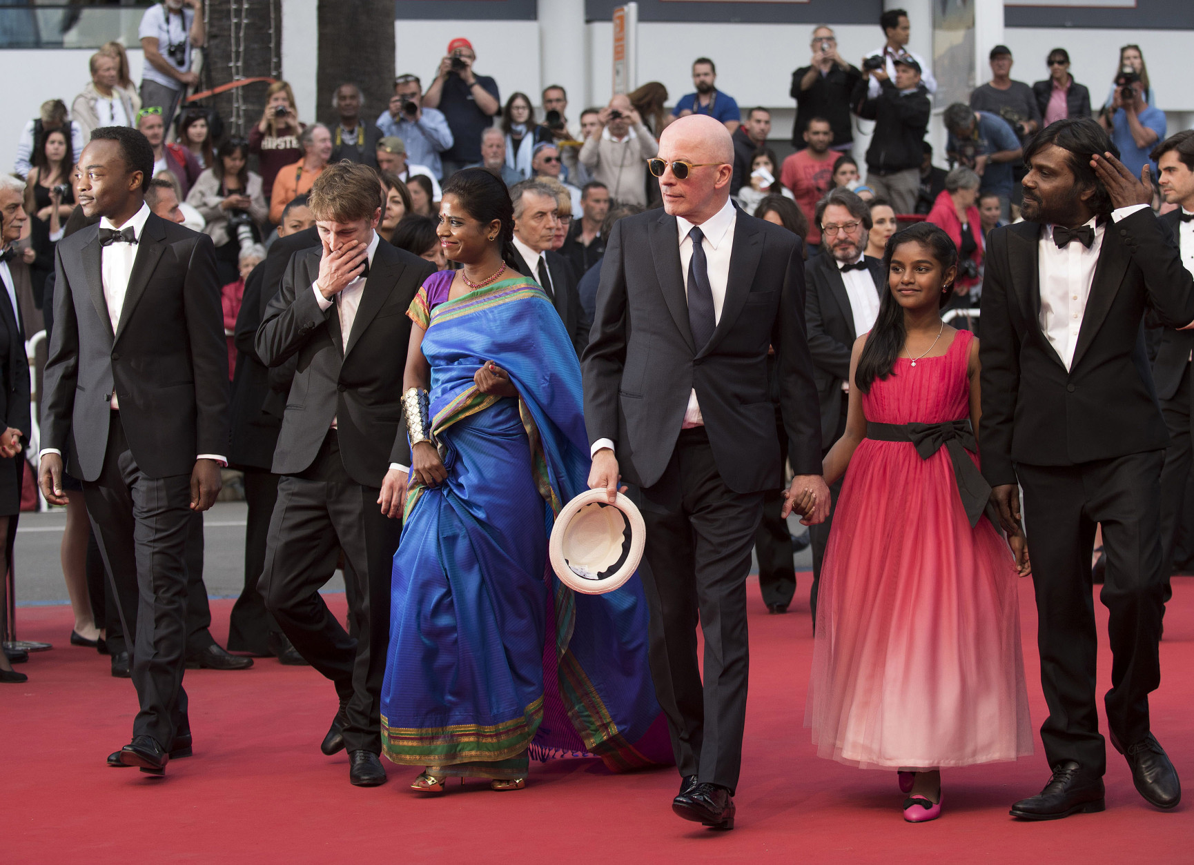 From left, Marc Zinga, Vincent Rottiers, Kalieaswari Srinivasan, director Jacques Audiard, Claudine Vinasithamby and Jesuthasan Antonythasan arrive for the screening of the film Dheepan at the 68th international film festival, Cannes, southern France, Thursday, May 21, 2015. (Photo by Arthur Mola/Invision/AP)