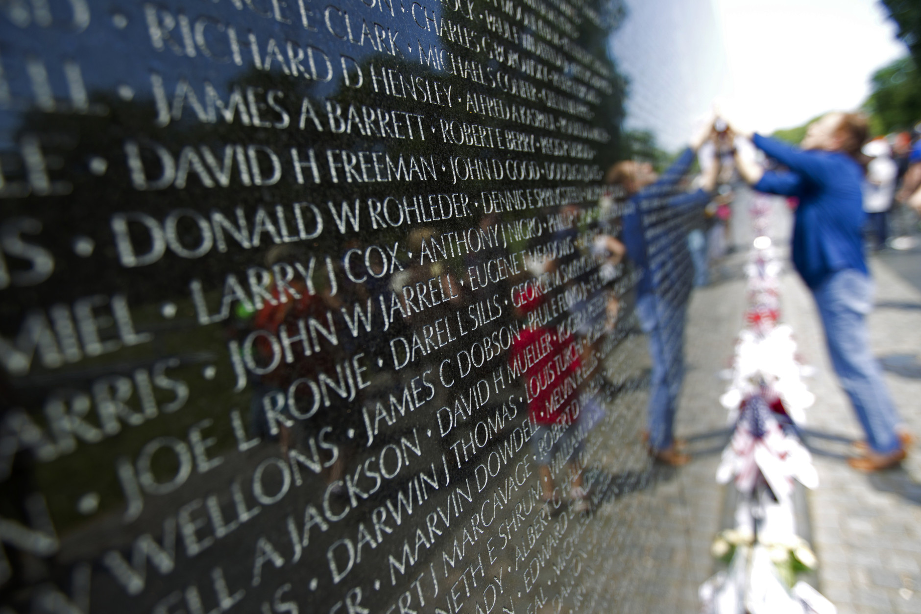 Visitors look at the names on the Vietnam Veterans Memorial wall, ahead of Memorial Day in Washington, Sunday, May 24, 2015.  (AP Photo/Jose Luis Magana)
