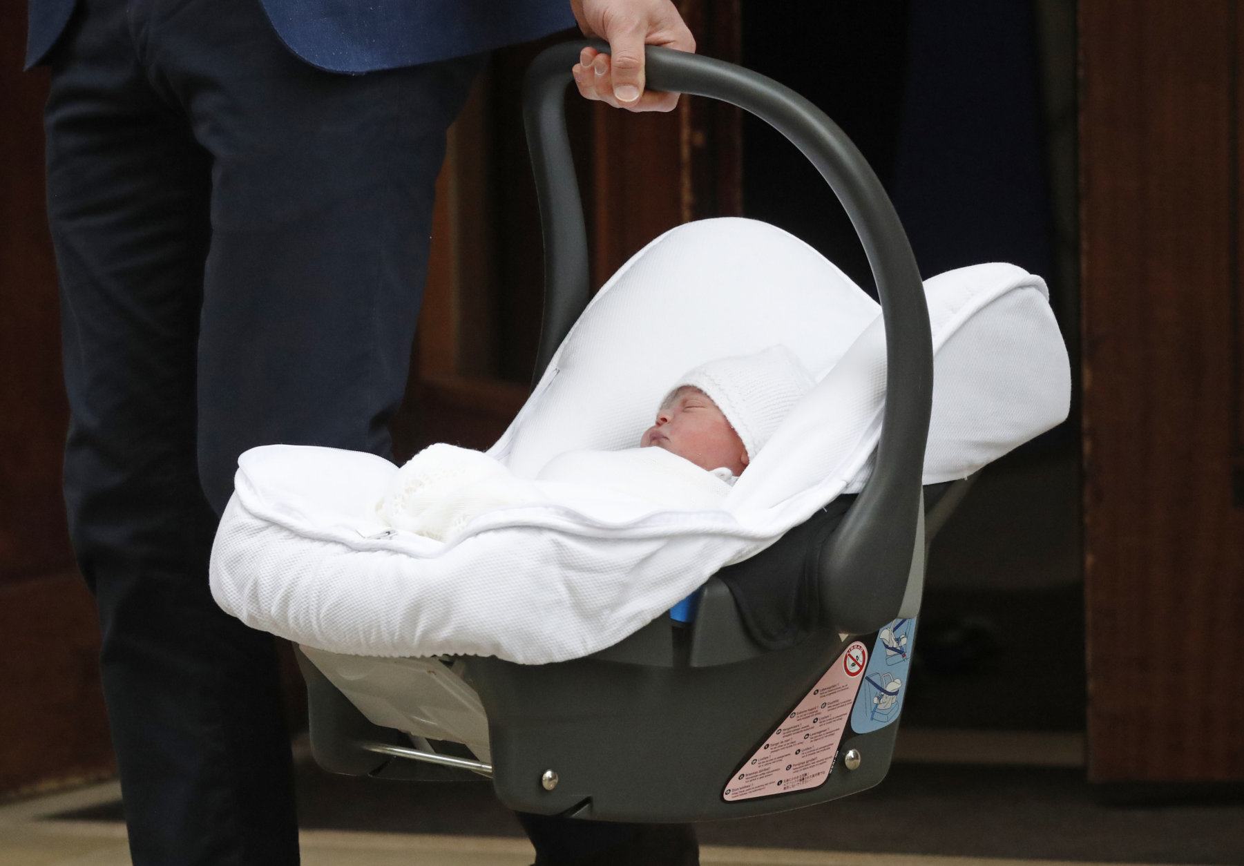 Britain's Prince William carries his newborn baby son as he leaves the Lindo wing at St Mary's Hospital in London London, Monday, April 23, 2018. The Duchess of Cambridge gave birth Monday to a healthy baby boy — a third child for Kate and Prince William and fifth in line to the British throne. (AP Photo/Frank Augstein)