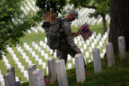 ARLINGTON, VA - MAY 21:  Specialist Michael Escobar of the 3rd U.S. Infantry Regiment places American flags at the graves of U.S. soldiers buried at Arlington National Cemetery, in preparation for Memorial Day May 21, 2015 in Arlington, Virginia. 'Flags-In' has become an annual ceremony since the 3rd U.S. Infantry Regiment (The Old Guard) was designated to be an Army's official ceremonial unit in 1948 (Photo by Win McNamee/Getty Images)
