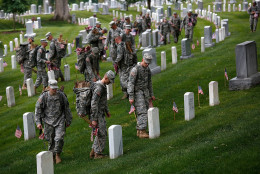 ARLINGTON, VA - MAY 21: Members of the 3rd U.S. Infantry Regiment place American flags at the graves of U.S. soldiers buried at Arlington National Cemetery, in preparation for Memorial Day May 21, 2015 in Arlington, Virginia. "Flags-In" has become an annual ceremony since the 3rd U.S. Infantry Regiment (The Old Guard) was designated to be an Army's official ceremonial unit in 1948 (Photo by Win McNamee/Getty Images)