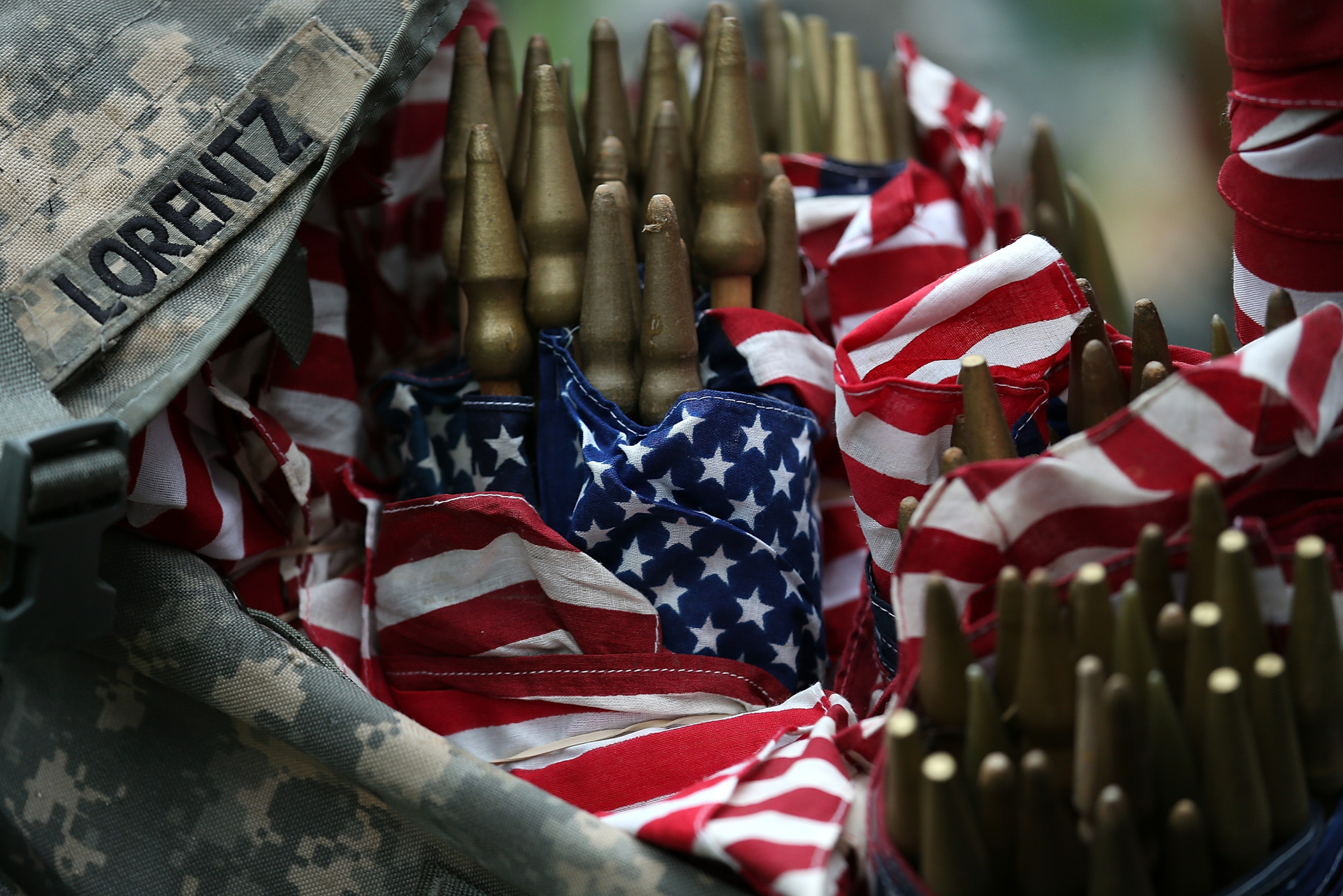ARLINGTON, VA - MAY 21:  Members of the 3rd U.S. Infantry Regiment load  American flags into their backpacks before placing them at the graves of U.S. soldiers buried at Arlington National Cemetery, in preparation for Memorial Day May 21, 2015 in Arlington, Virginia. "Flags-In" has become an annual ceremony since the 3rd U.S. Infantry Regiment (The Old Guard) was designated to be an Army's official ceremonial unit in 1948  (Photo by Win McNamee/Getty Images)