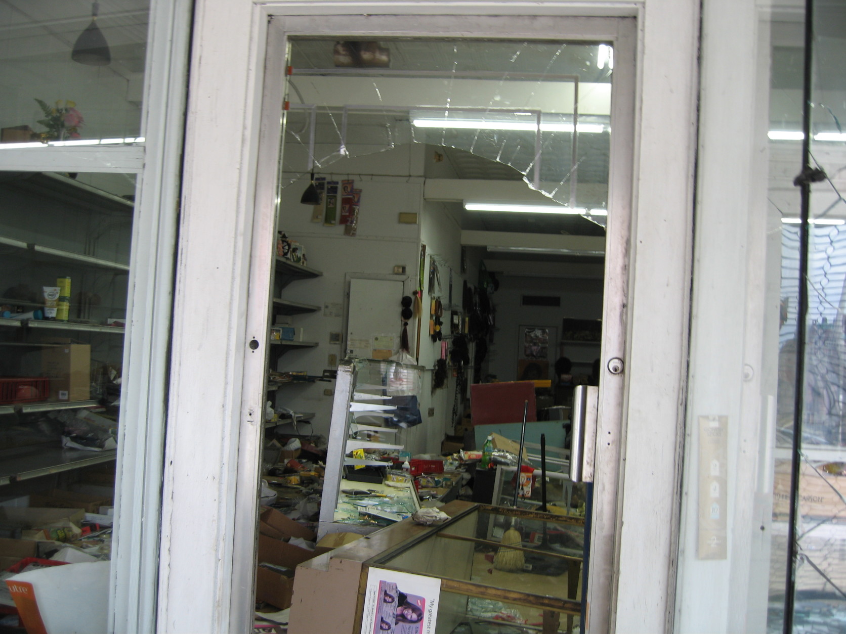 Looters broke the windows to get into J-mart Wigs. (Courtesy Matthew Chung)