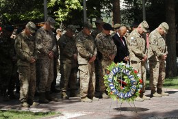 General John F. Campbell, commander of international forces in Afghanistan, second right, gives respect during a ceremony marking Memorial Day at the Resolute Support main headquarters in Kabul, Afghanistan, Monday, May 25, 2015. Over 2,300 American soldiers and more than 11,00 coalition soldiers have lost their lives in action during the last 14 years in Afghanistan. (AP Photo/Allauddin Khan)