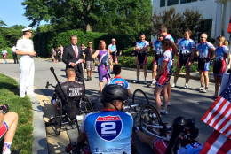 Commander Larry Meehan and Defense Secretary Ash Carter/greet wounded warrior cyclists in front of the vice president's residence Monday Morning. The cyclists will ride from D.C. to Virginia Beach. (WTOP/Kristi King)
