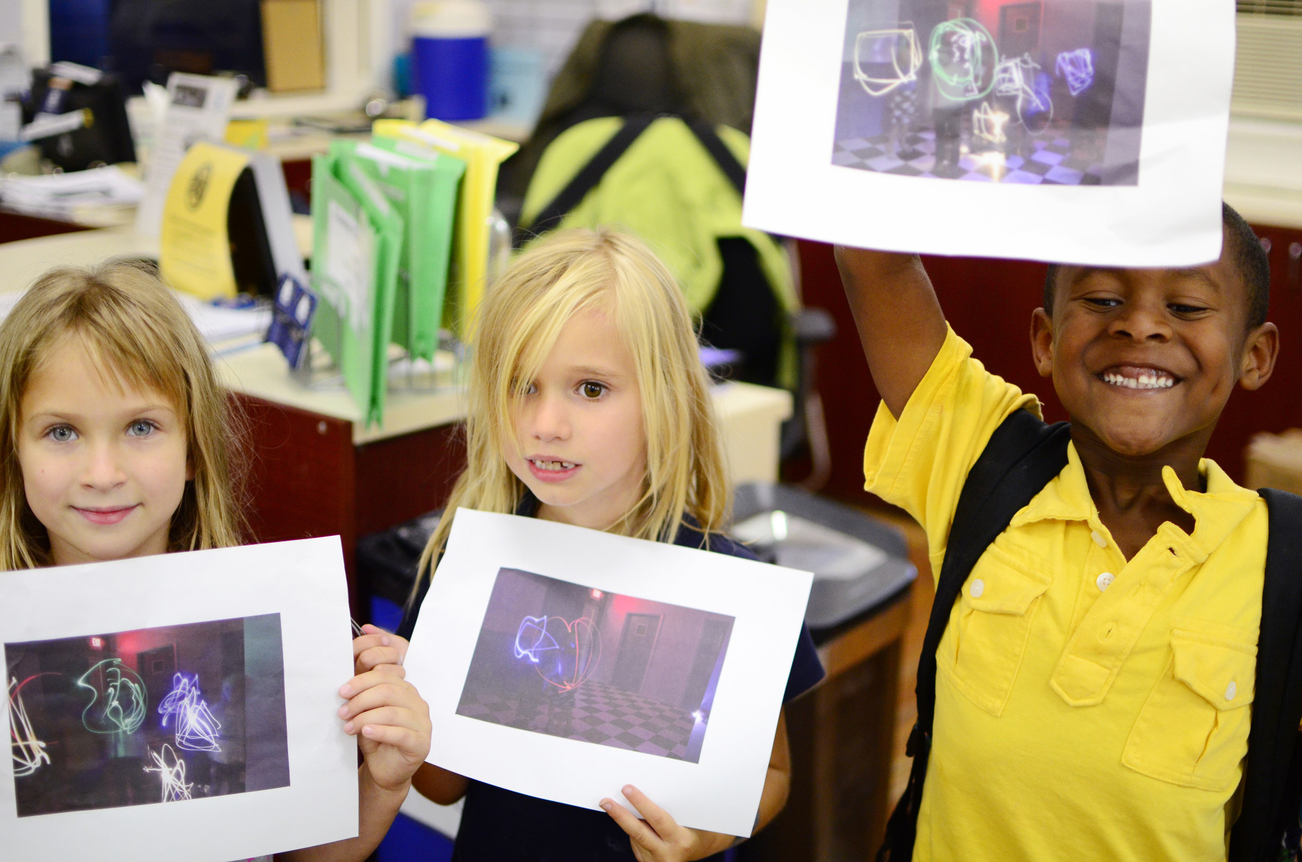 Proud CHAW students showing off their work from photography class.  (Leslie Mansour/CHAW)