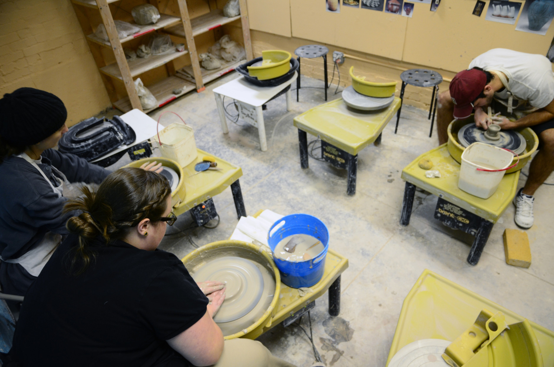 Adult students working on centering their pottery-in-progress on the ceramics wheel. (Leslie Mansour/CHAW)