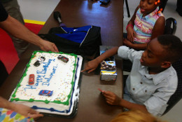 Dahmari Jenkins receives cake in celebration of his birthday and survival after being cut with a scalpel. (WTOP/Megan Cloherty)