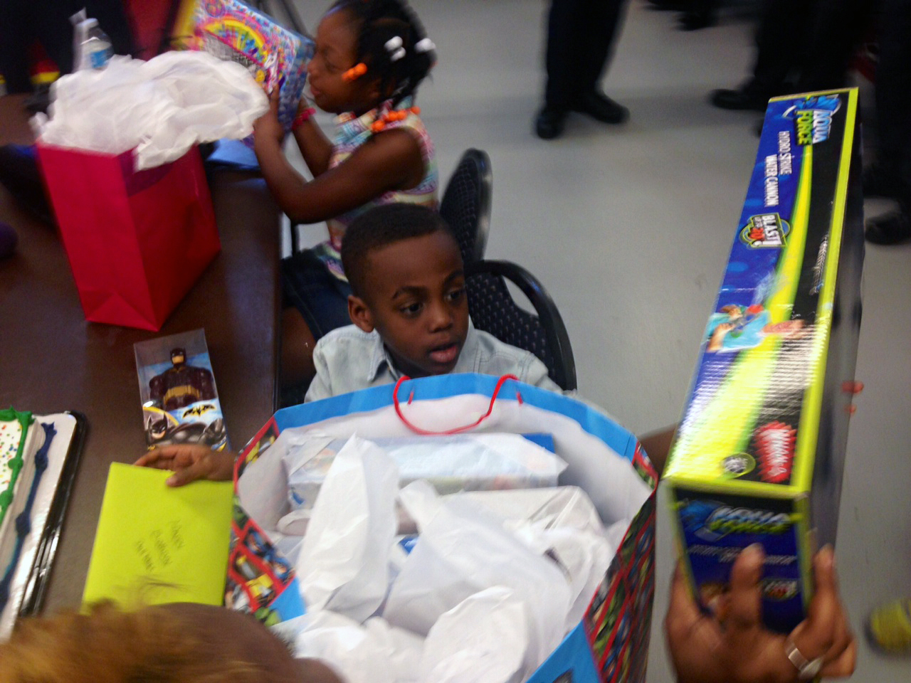 Dahmari Jenkins receives presents in celebration of his birthday and survival after being cut with a scalpel. (WTOP/Megan Cloherty)