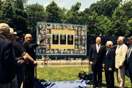 Medal of Honor recipients admire enlarged image of three new Forever Stamps.  (WTOP/Dick Uliano)