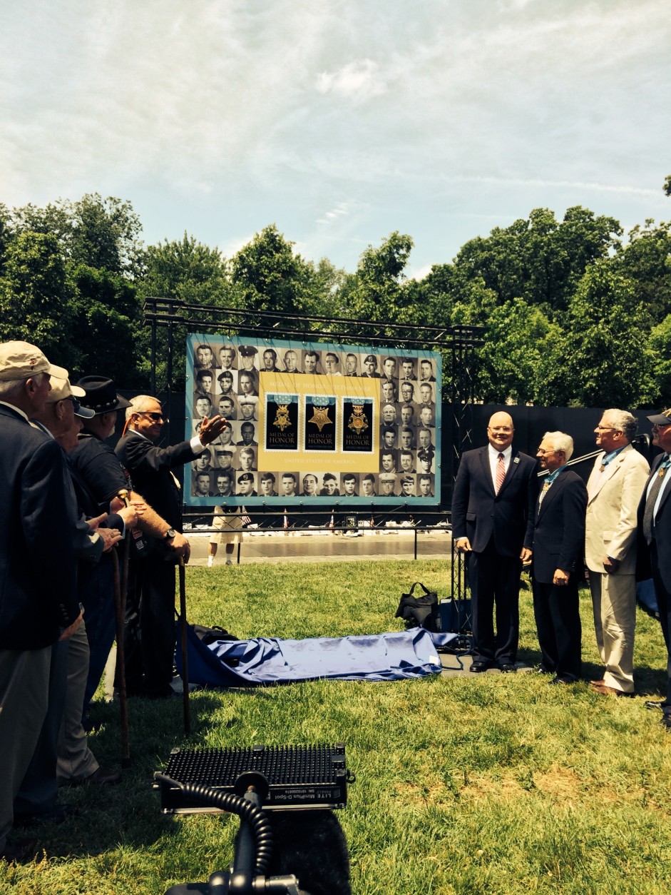 Medal of Honor recipients admire enlarged image of three new Forever Stamps.  (WTOP/Dick Uliano)