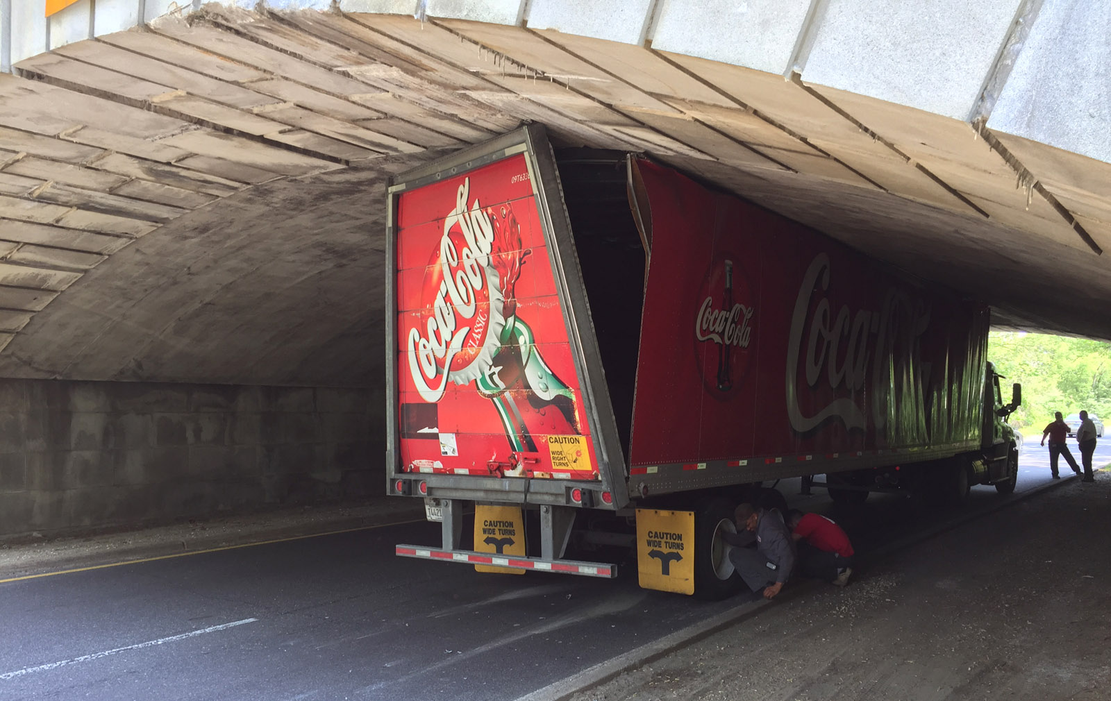 The entire length of a Coca-Cola truck is wedged beneath the Memorial Bridge along the George Washington Memorial Parkway Tuesday afternoon.  (WTOP/Jim Battagliese)