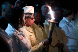 A member of Golden Star Mothers passes the torch to another during a Memorial Day candlelight vigil at the Vietnam Veterans Memorial in Washington, Friday, May 22, 2015. (AP Photo/Jose Luis Magana)