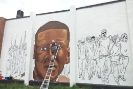 On the other side, the mural depicts modern youth who gathered for Freddie Gray's vigil. (WTOP/Andrew Mollenbeck)