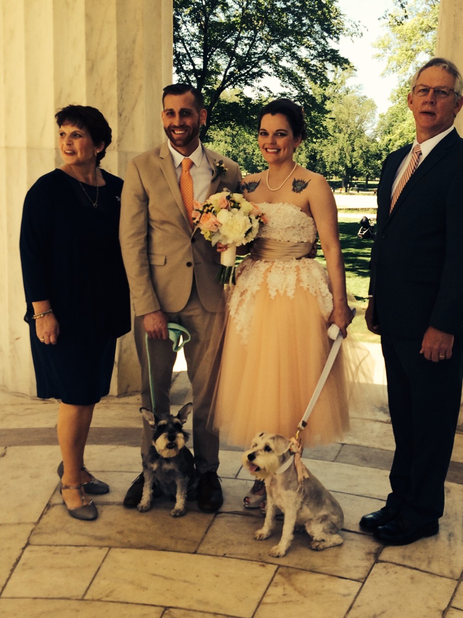 Mattie and Celia hold their pet dogs and pose with family members. (WTOP/Dick Uliano)