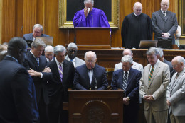 <p>Chaplain James St. John, center, leads senators in prayer on Thursday at the Statehouse in Columbia, S.C. State Sen. Clementa Pinckney was one of those killed Wednesday night in a shooting at the Emanuel AME Church in Charleston.</p>