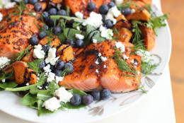 This March 16 2015 photo shows broiled sockeye salmon with blueberries and sweet potatoes in Concord, NH. (AP Photo/Matthew Mead