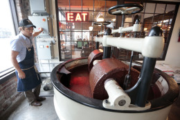In this April 6, 2015, photo, Scott Witherow, founder and owner of Olive and Sinclair Chocolate, operates his stone grinders to grind cacao beans in the East Nashville area of Nashville, Tenn. The East Nashville neighborhood houses an eclectic collection of restaurants, bars, coffee shops, bakeries and stores, mixed into a residential area of 1950s and 1960s homes. (AP Photo/Mark Humphrey)