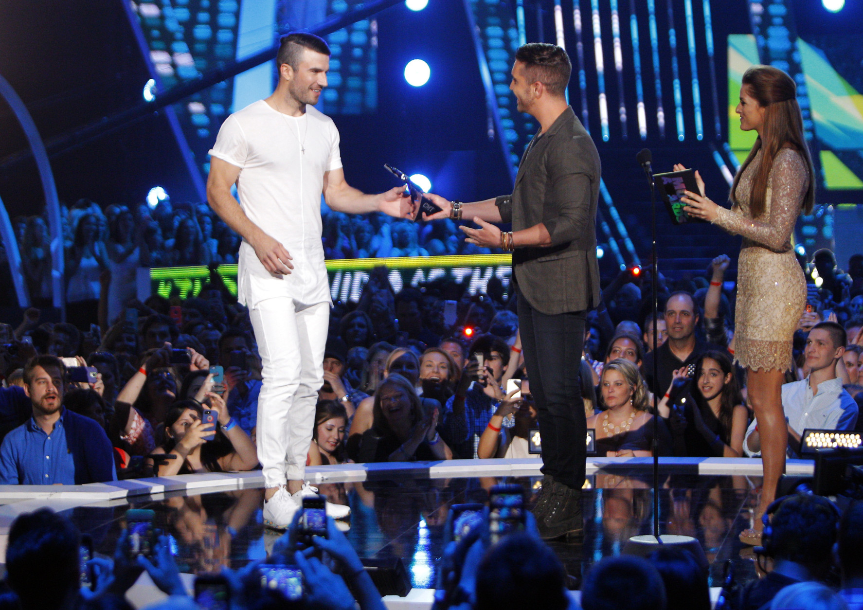 Cassadee Pope, from right, and Nick Fradiani present the award for breakthrough video of the year to Sam Hunt for "Leave the Night On" at the CMT Music Awards at Bridgestone Arena on Wednesday, June 10, 2015, in Nashville, Tenn. (Photo by Wade Payne/Invision/AP)