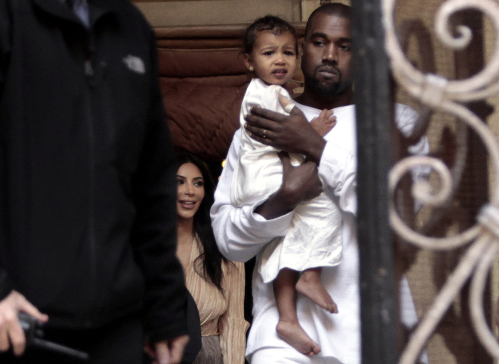 Kim Kardashian, a US reality TV star, and her husband Kanye West holding their daughter North West, walk inside Armenian St. James Cathedral, in Jerusalem, Monday, April 13, 2015. Kim Kardashian, along with husband West, their daughter, North West, and her sister, Khloe, arrived to Israel on a private visit.  (AP Photo/Mahmoud Illean)